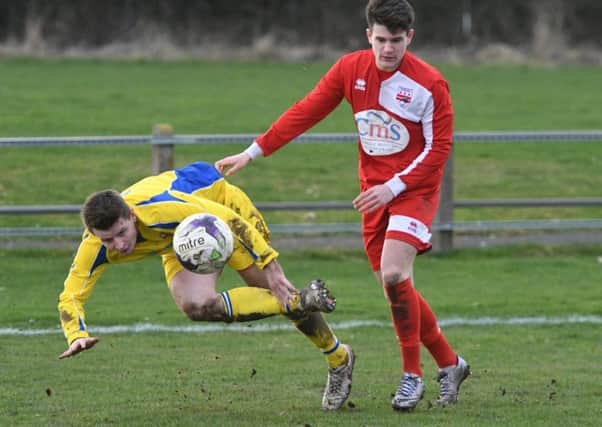 Chester-le-Street (yellow) clear their lines in Saturday's 3-3 draw at Washington. Picture by Kevin Brady