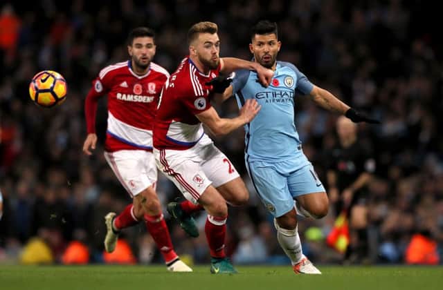 Middlesbrough's Calum Chambers (left) and Manchester City's Sergio Aguero battle for the ball.