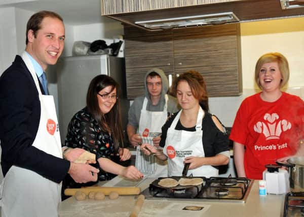 The Duke of Cambridge making chapatis in the kitchen of Centrepoint, Dundas Street, Sunderland, in 2013.