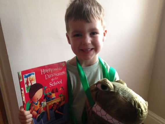 Archie Rodgerson celebrates World Book Day as Harry and one of his Dinosaurs.