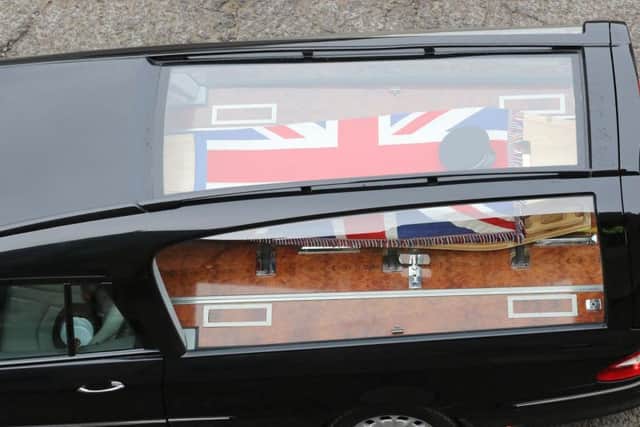 Pc Gavin Smith's coffin was draped with a flag and decorated with his police hat.
