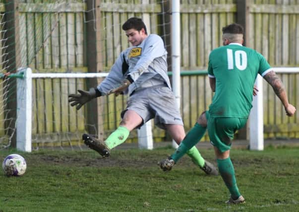 David Paul fires home for Easington Colliery (green) in Saturday's dramatic clash with Alnwick Town. Picture by Kevin Brady