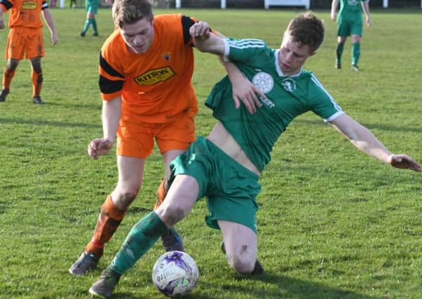Easington Colliery (green) scrap it out with Alnwick Town in Saturday's thrilling Second Division clash. Picture by Kevin Brady