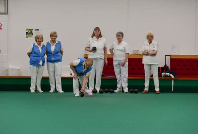 Houghton Ladies' Hala Collingwood bowls, watched by club-mates Audrey Latimer and Ann Banks