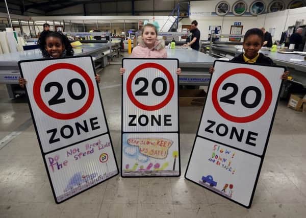 Promoting their work are, from left, Divine Erhunmwunse (Please do not break the speed limit); Amelia Parker (Stay slow keep us safe) and Ofe Isanbor (Slow down and be safe).