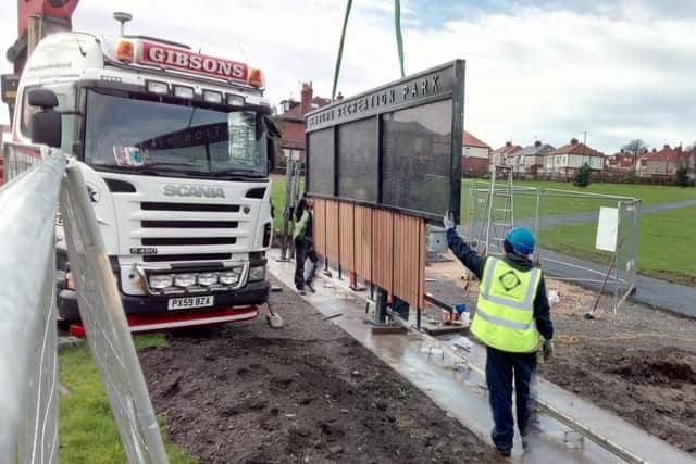 The new metal gates at Seaburn Recreation Park are lowered into place by workers.