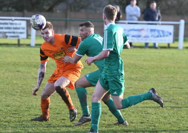 Easington Colliery striker David Paul (green) chases down a ball in last week's 4-3 win over Alnwick Town. Picture by Kevin Brady