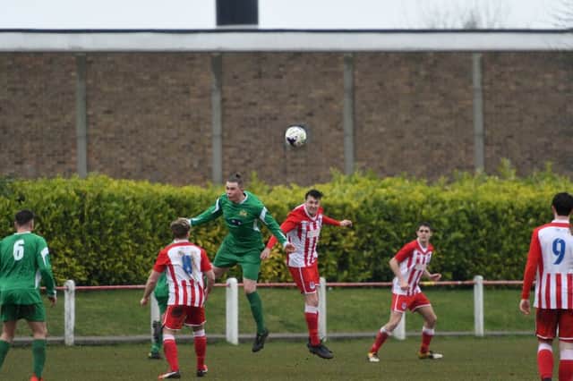 Seaham Red Star (red/white) take on Newcastle Benfield (green) at Seaham Town Park on Saturday. Picture by Kevin Brady