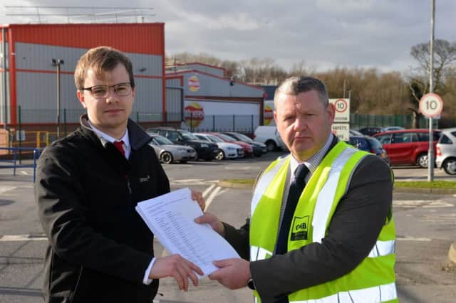 Councillor Darren Meadows hand on the document to GMB representative Michael Hunt.