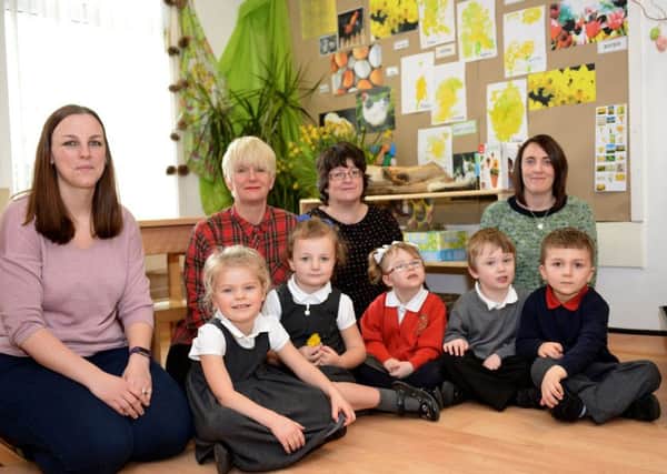 (left to right) Kim Duncan (parent) Kathryn Williams (staff), Joanne Coulson (head) and Vicky Cooper (staff) with children at Mill Hill Nursery.  Picture by FRANK REID
