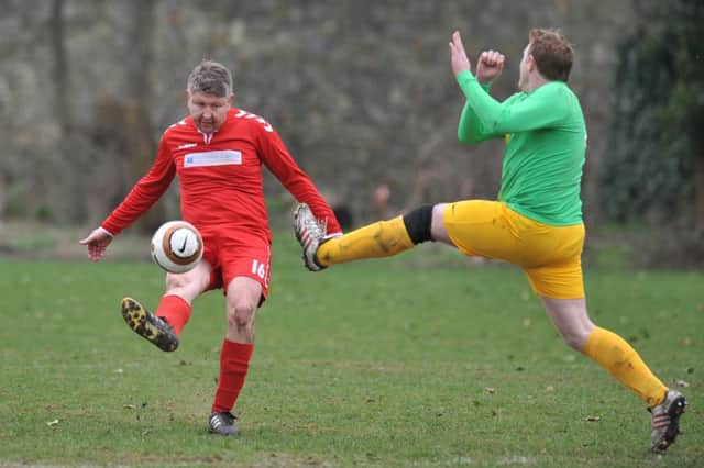 Consett (green) defend against Wearmouth CW in their Over-40s Cup clash last week. Picture by Tim Richardson