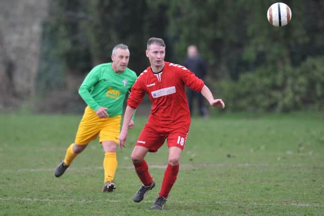 Eyes on the ball as Wearmouth CW (red) take on Over-40s rivals Consett. Picture by Tim Richardson