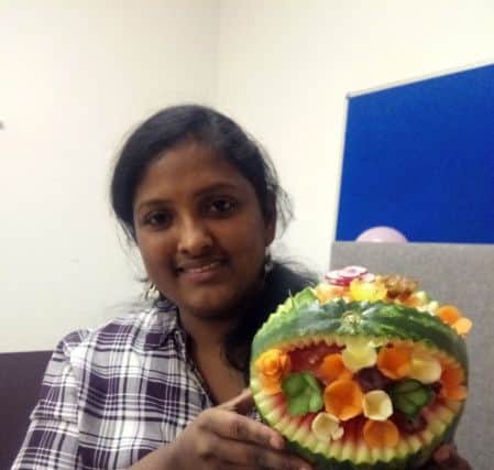 Vijayalakshmi Subramani  with her carved fruit display, which was created in front of the crowd.