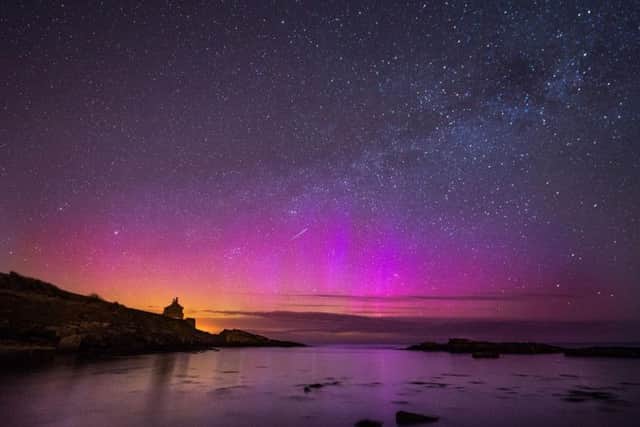 The Northern Lights, or Aurora Borealis, shining over the Bathing House in Howick, Northumberland. Pic: Owen Humphreys/PA Wire.