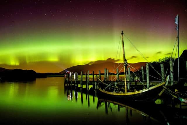 The Northern Lights, or Aurora Borealis, shining over Derwentwater, near Keswick in the Lake District. Pic: Owen Humphreys/PA Wire.