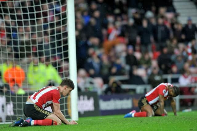 Billy Jones and Jermain Defoe look down at the turf after a chance goes begging
