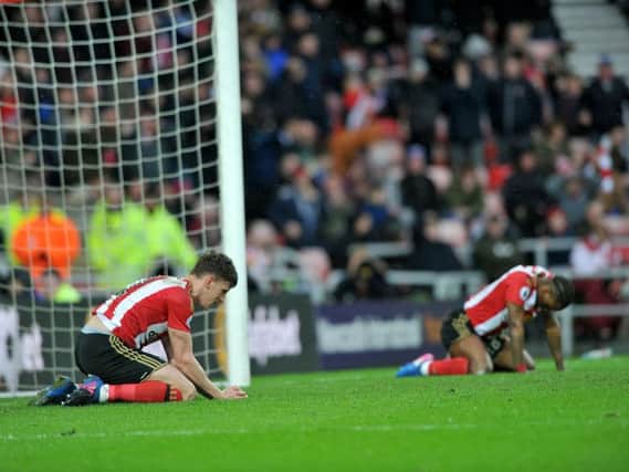 Billy Jones and Jermain Defoe look down at the turf after a chance goes begging