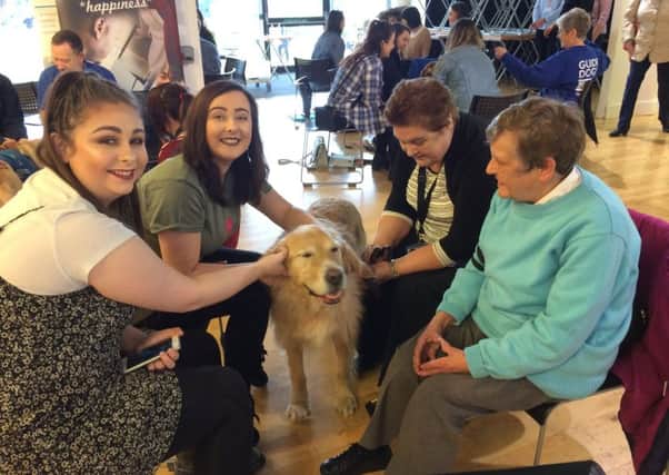 At the University of Sunderland are, from left, two students, Dorothy Richardson with her guide dog Terra and Guide Dogs Sunderland fundraising group secretary Pat Orrell.