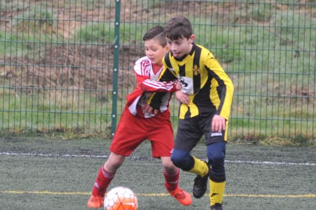 Russell Foster Under 10's Cup Competition action between Ouston Juniors Magpies v Wearside Lions FC (red white), played at Monkton Stadium, Jarrow.