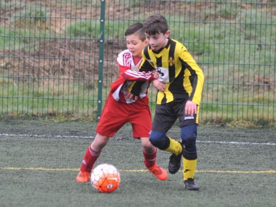 Russell Foster Under 10's Cup Competition action between Ouston Juniors Magpies v Wearside Lions FC (red white), played at Monkton Stadium, Jarrow.