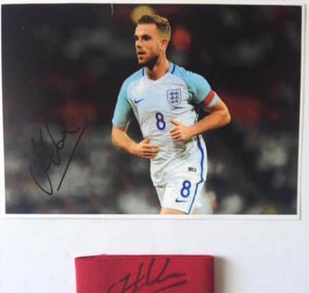 The signed captain's armband and photograph donated to the SAFC Museum by Jordan Henderson.