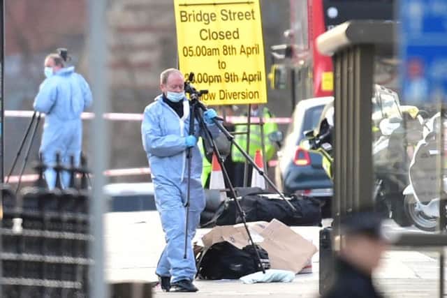 Police forensic officers on Westminster Bridge, close to the Palace of Westminster, London, after policeman has been stabbed and his apparent attacker shot by officers in a major security incident at the Houses of Parliament.