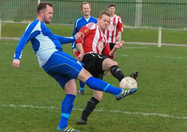 Sunderland West End (red and white) battle against Jarrow last weekend.