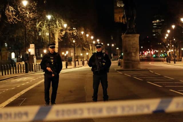 Two policemen stand guard at a cordoned off area on the way to the Houses of Parliament in central London last night (AP Photo/ Matt Dunham)