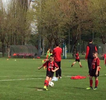 Reid-Thomas Coyne trains hard during his visit to AC Milan's soccer camp.