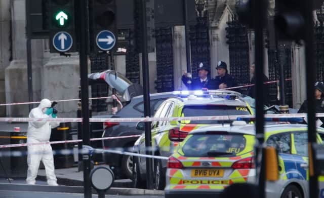 Police forensic officers close to the Palace of Westminster. Picture by PA.