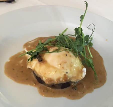 Black pudding and poached egg with peppercorn sauce