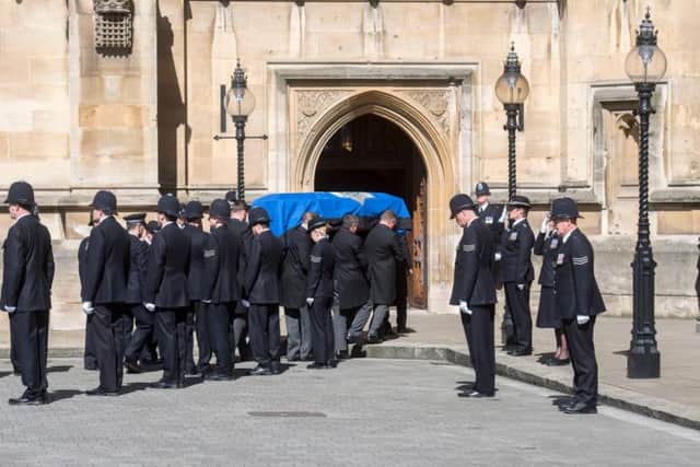 The coffin of Pc Keith Palmer passing a police guard of honour as it arrived at Westminster's Chapel of St Mary Undercroft in London, where he rested overnight ahead of a full police funeral at Southwark Cathedral. Paul Grover/Daily Telegraph/PA Wire