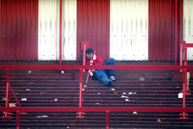 One fan sits on the old Roker End.