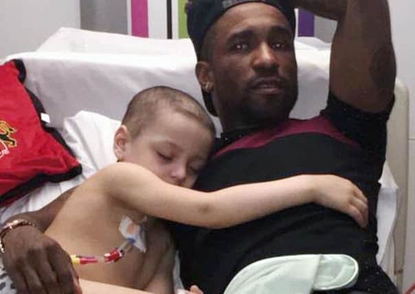 Bradley Lowery with Jermain Defoe during a visit to his hospital ward.