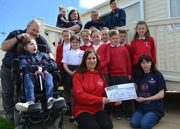Redby Academy pupils hand over cash to Out of Sight.