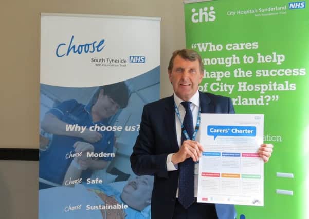 Ken Bremner, chief executive of City Hospitals Sunderland with the Carers Charter.