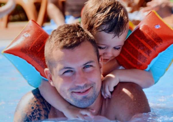 :Lee Gibson with his son Smith on holiday. Picture by FRANK REID