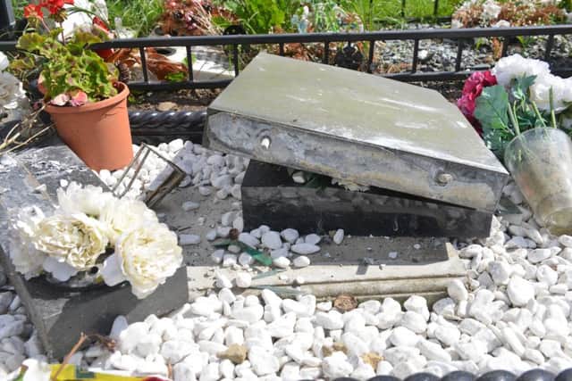 Damage to Theresa Lincoln's grave and a neighbouring grave.