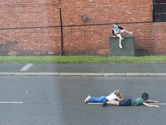 The photo of children lying in the road have been issued as part of the alert.
