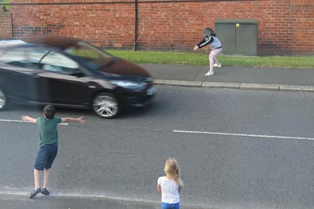 Another image shows children close to moving cars.