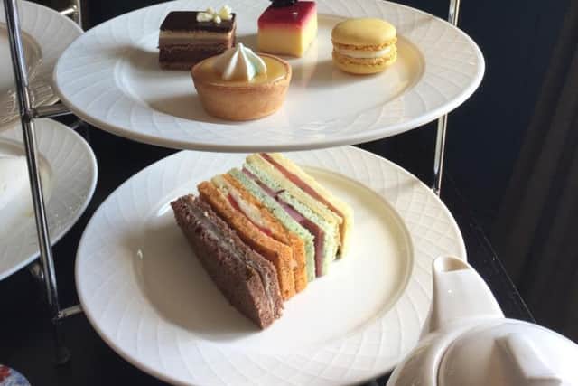 Sandwiches and cakes on the afternoon tea platter.