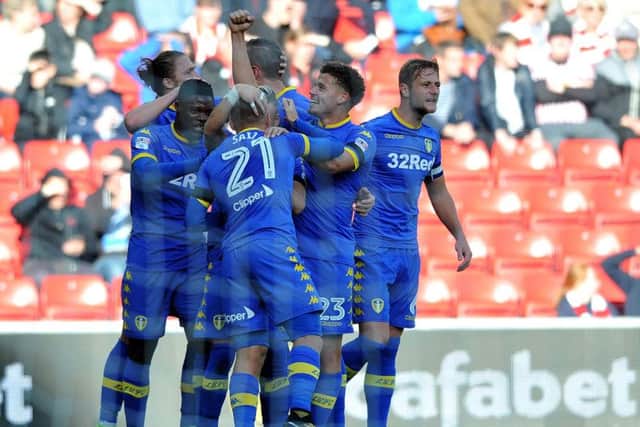 Leeds United players celebrate the opening goal.