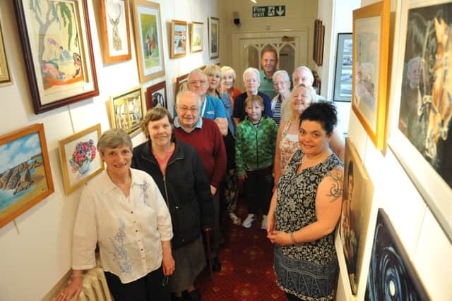 Artists with their work on display at Eastington's Seaton Holme.