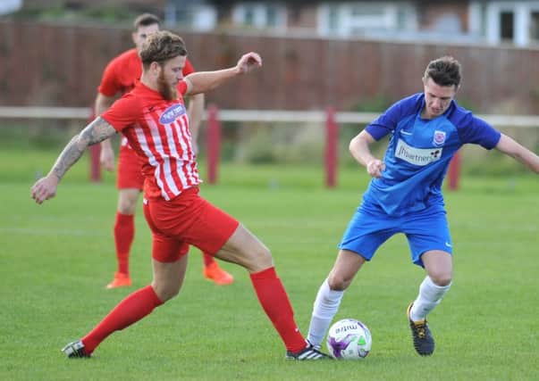 Ryhope CW FC (red) battle against Seaham Red Star on Saturday