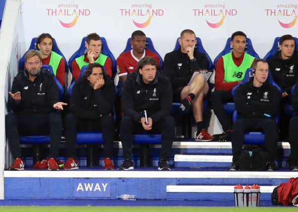 Liverpool manager Jurgen Klopp (left), players and staff sit dejected on the bench during the Carabao Cup, third round match at the King Power Stadium, Leicester.