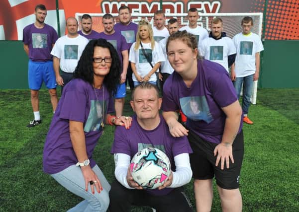Tonia, Arthur and Hayley Crighton, with footballers paying tribute to their son Jamie.