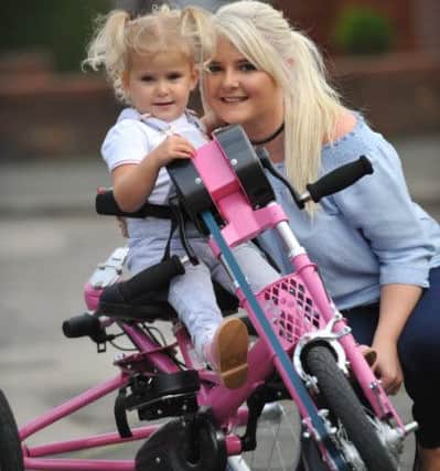 Rubie O'Brien on her new pink trike with mum Ciara.