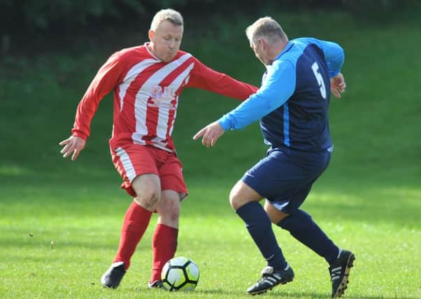Pennywell Vets (red) take on Doxy Lad in the Over-40s League last weekend