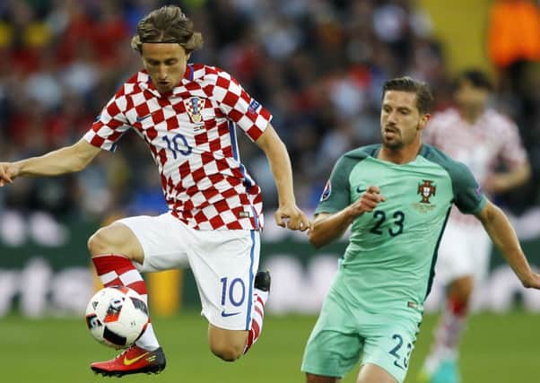 Adrien Silva takes on Croatia's Luca Modric.