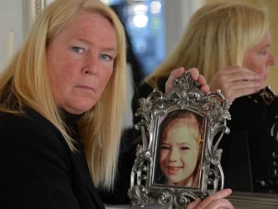 Sharon Henderson with a picture of her daughter Nikki Allan on the eve of the 25th anniversary of her disappearance.